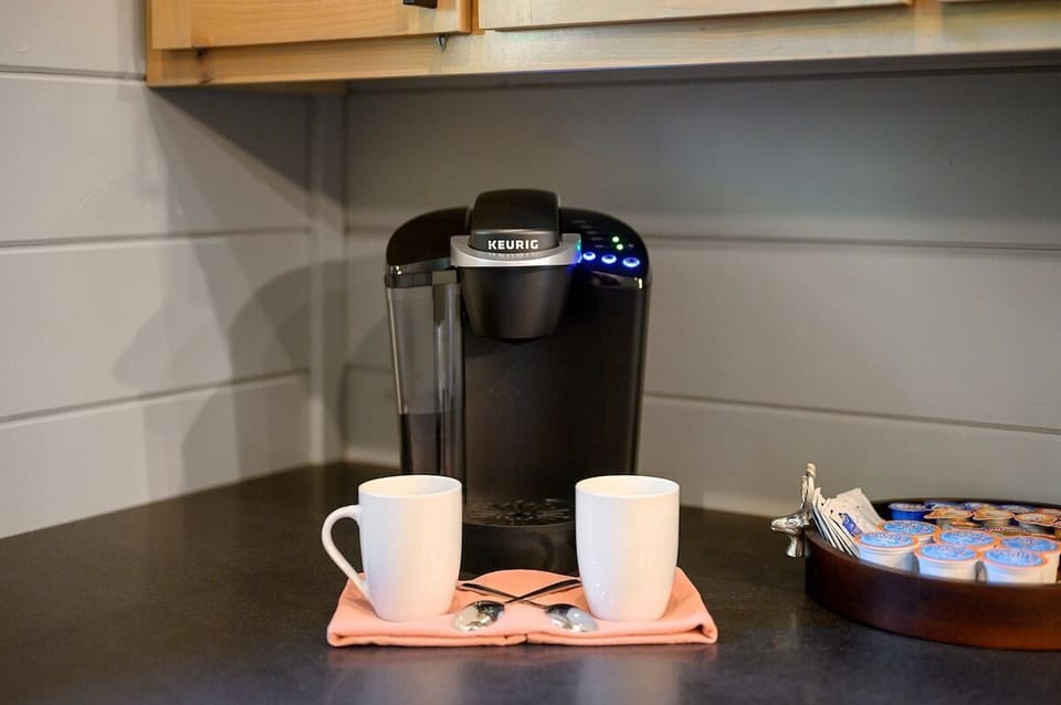 Cozy coffee corner with Keurig machine, mugs, and K-cups – ideal for your morning caffeine fix