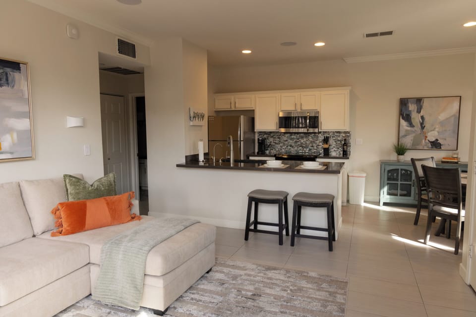 Open living/kitchen with eat at bar for two. 