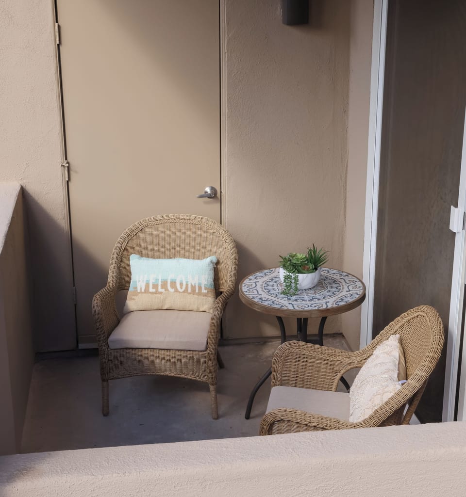 Cozy patio overlooking beautiful green space.  Perfect of bird watching.
