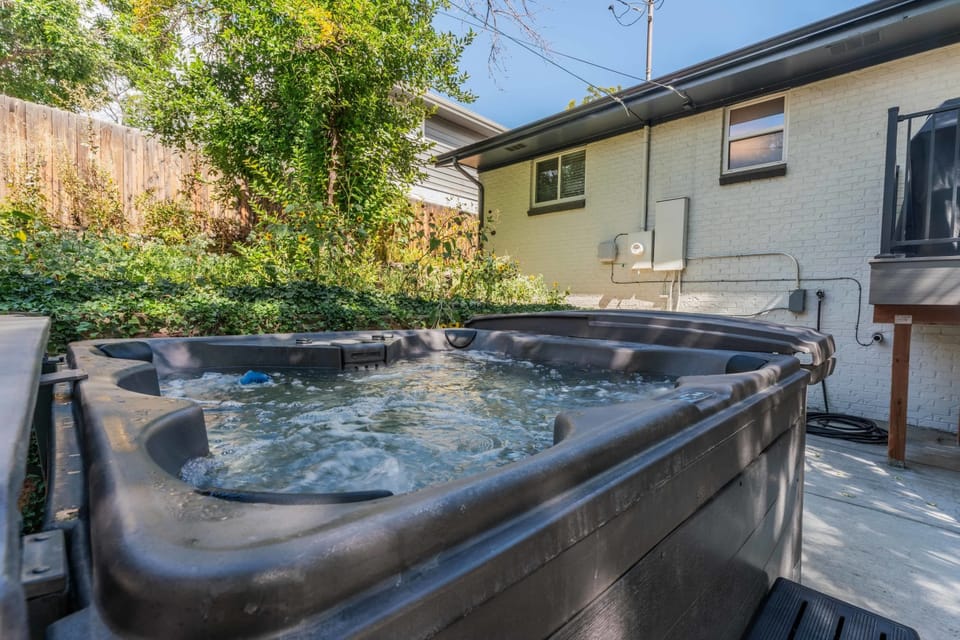 Outdoor Oasis: Unwind in your private hot tub surrounded by lush greenery and tranquility!