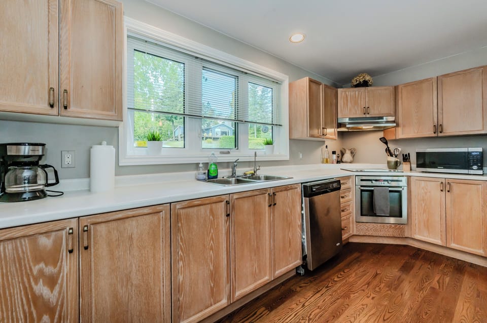 The kitchen is stocked with modern appliances and offers a peaceful view of the quiet, tree-lined neighborhood. Perfectly equipped for all your cooking needs, it’s the ideal space to prepare meals during your Bruce Peninsula getaway.