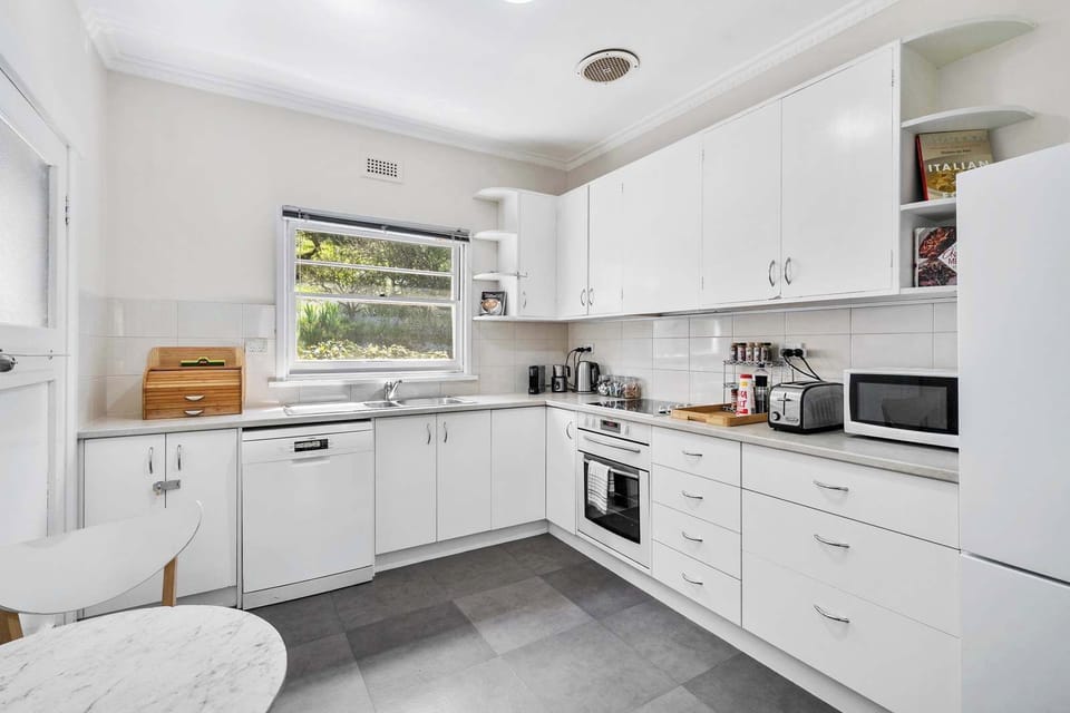 Well-appointed Kitchen with microwave, oven, stove dishwasher and coffee machine.