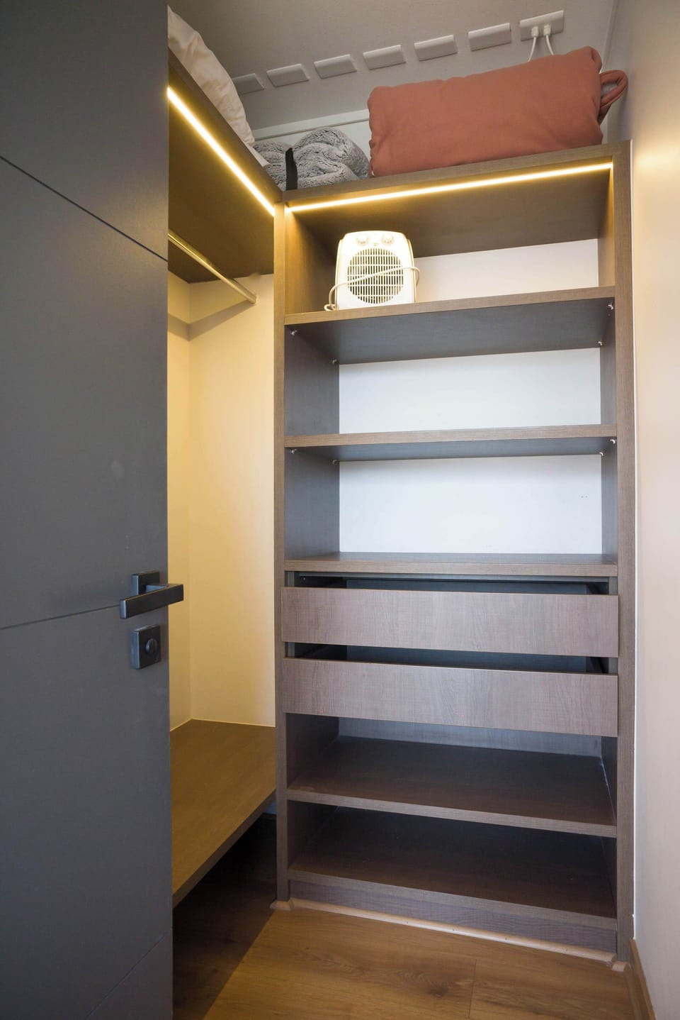 Spacious closet with ample shelving and storage, perfect for organizing your belongings during your stay.
