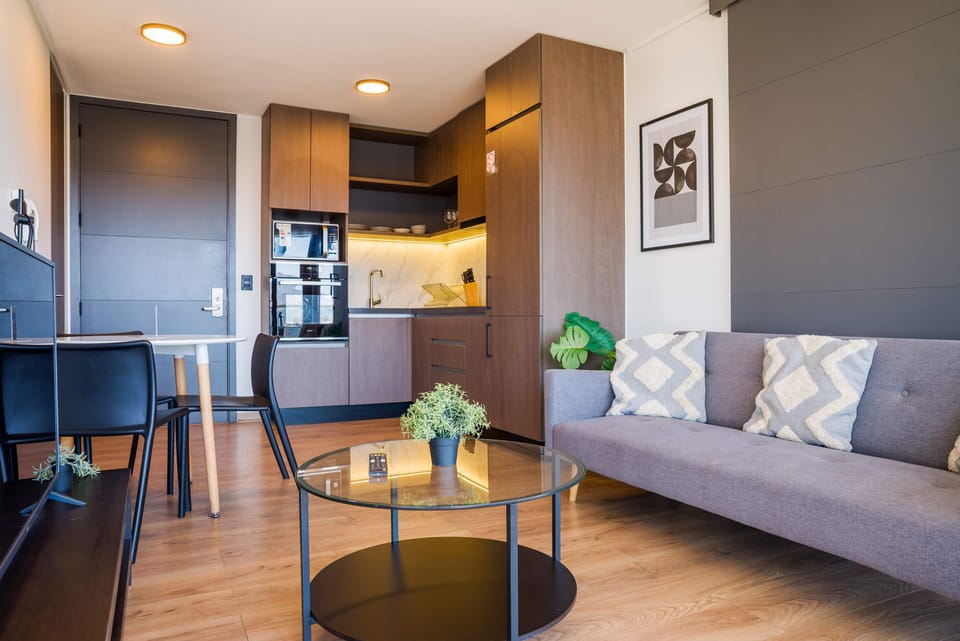 Cozy living space with modern kitchen and stylish decor, perfect for relaxation and dining.