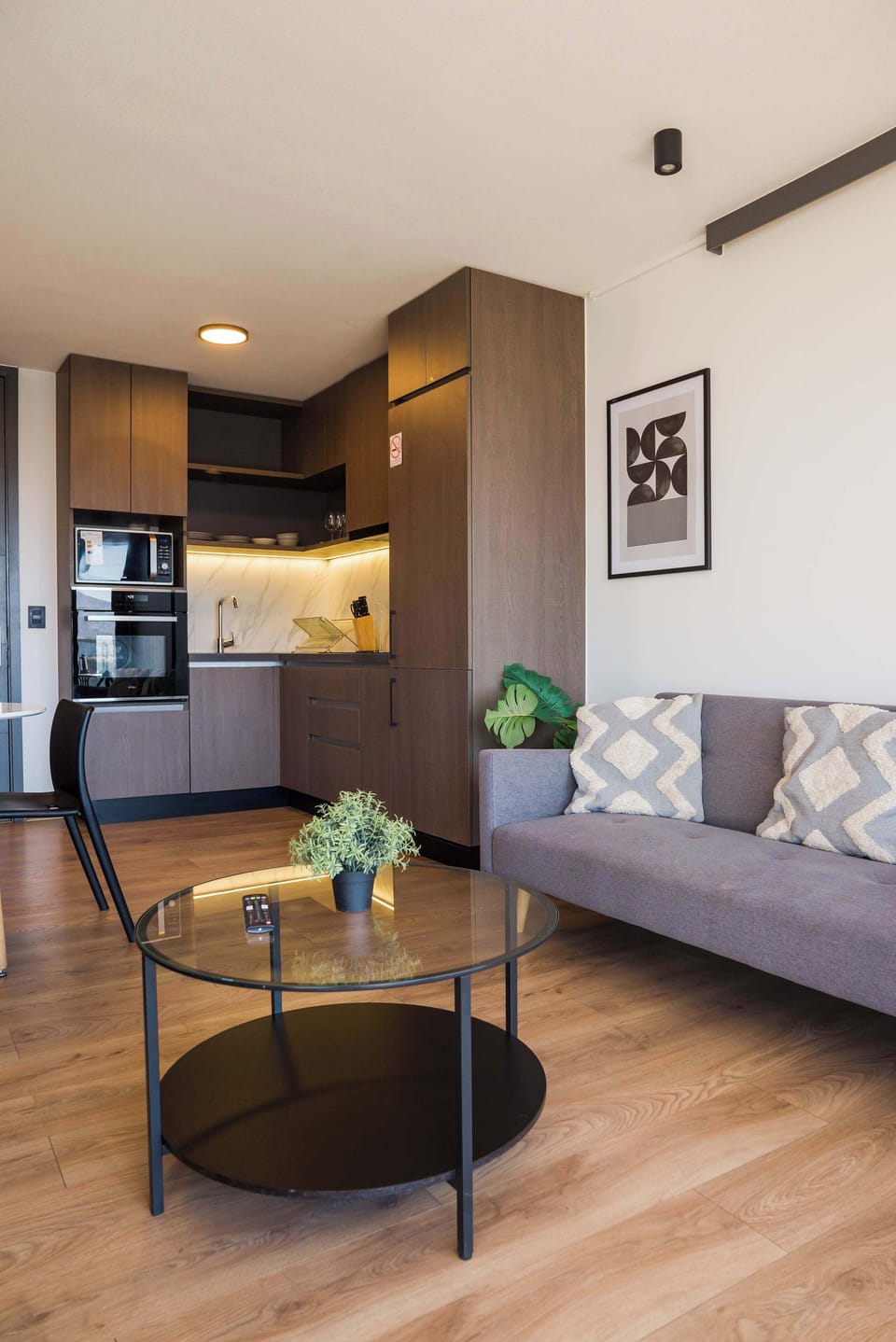 Cozy living area with modern kitchen and stylish decor, perfect for relaxing after a day exploring the city.