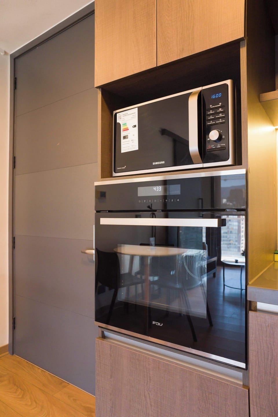 Modern kitchen with sleek appliances and a cozy dining area, perfect for cooking and enjoying meals.