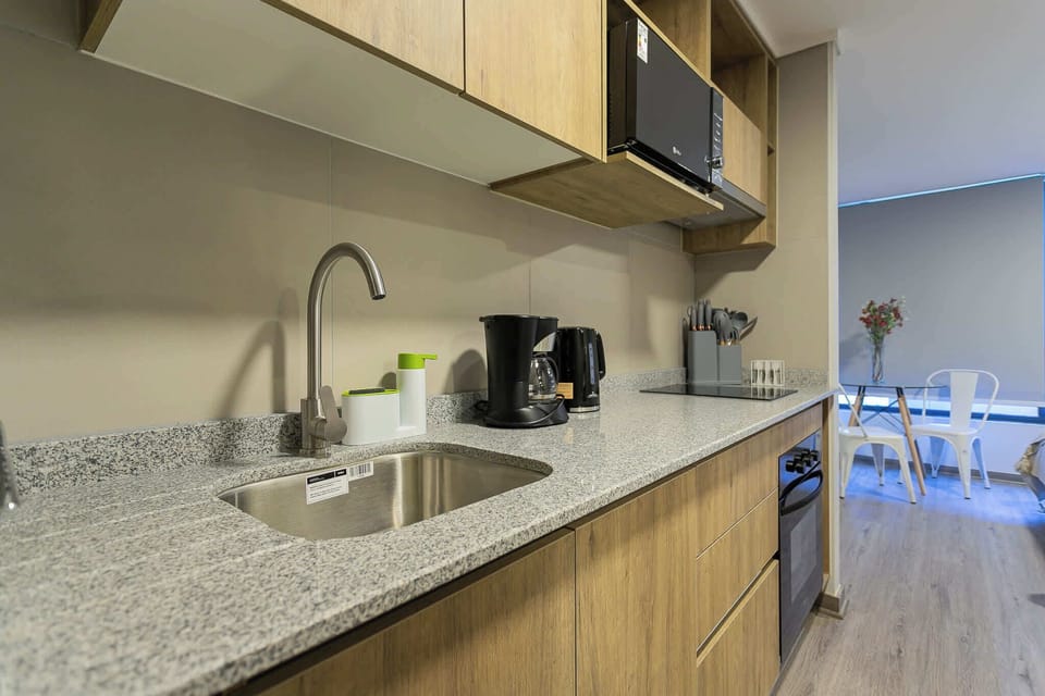 Experience culinary convenience in this sleek, modern kitchen with all essentials for a perfect stay.
