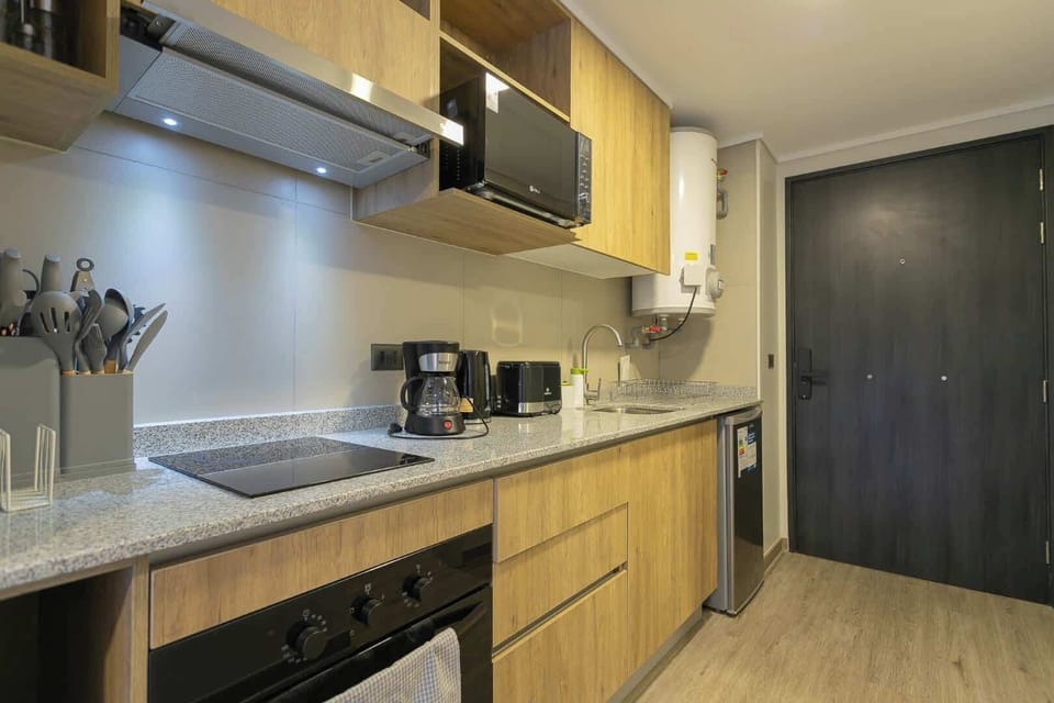 Fully equipped modern kitchen with sleek appliances and ample storage, perfect for a cozy stay.