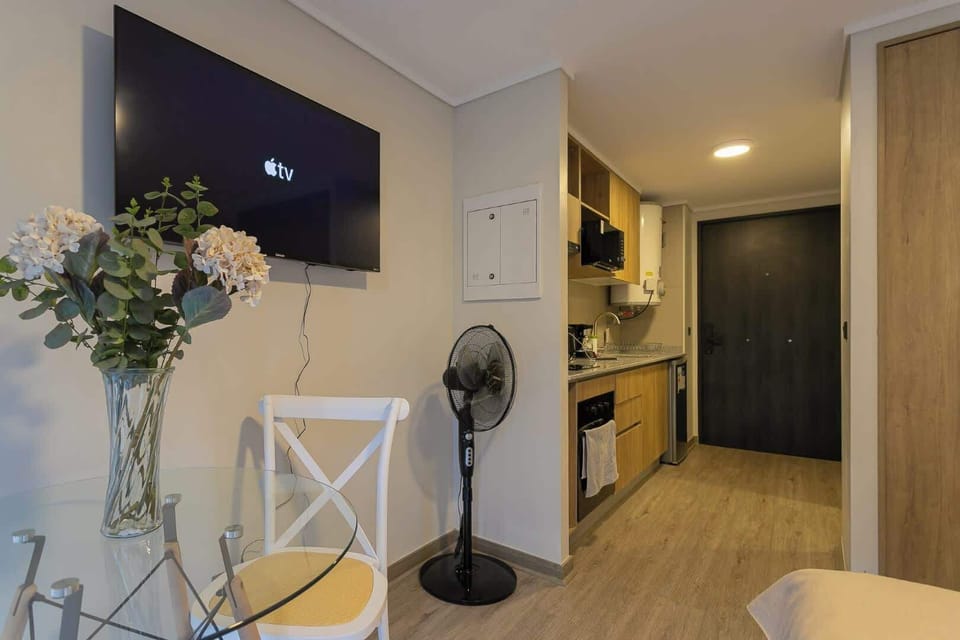 Cozy studio kitchen with modern amenities and a relaxing dining area, perfect for a comfortable stay.