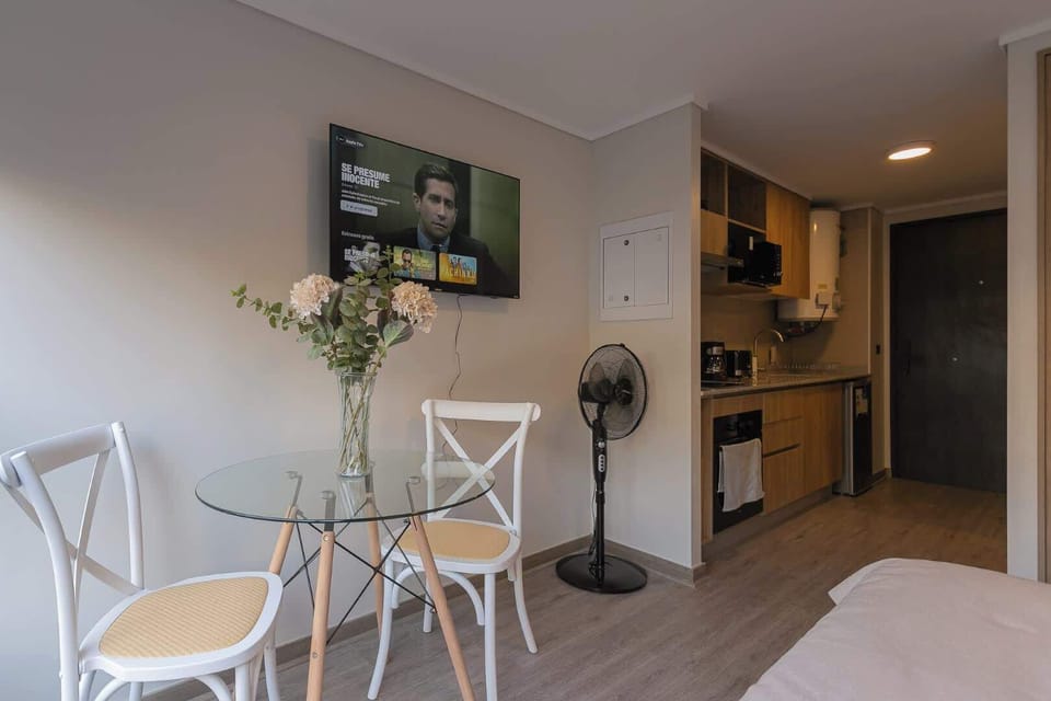 Cozy studio with a modern kitchen and dining area, perfect for a relaxing stay in the heart of the city.