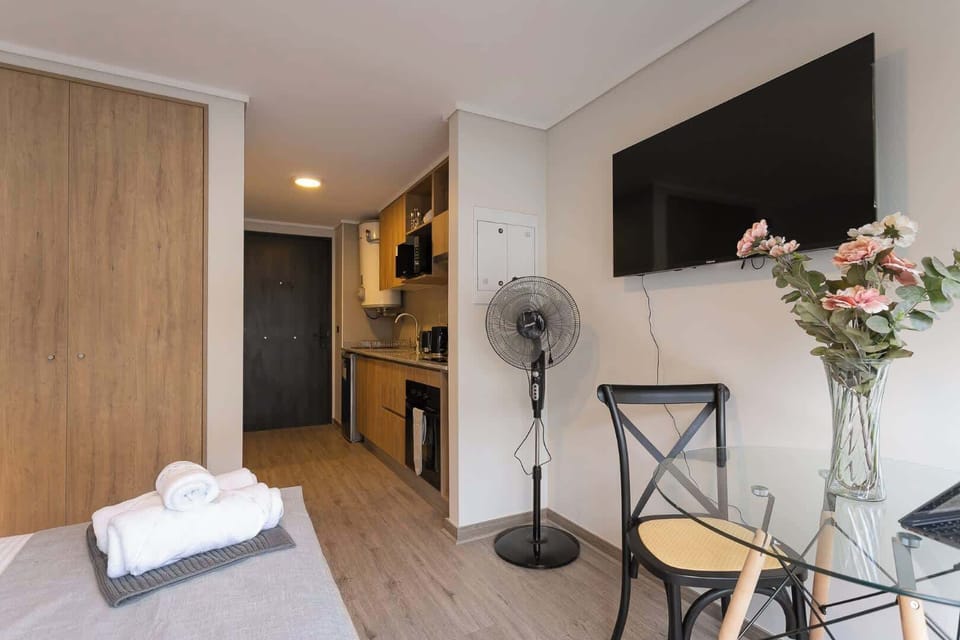 Cozy studio with modern amenities, perfect for a comfortable stay. Enjoy a well-equipped kitchen and relax with entertainment on the wall-mounted TV.