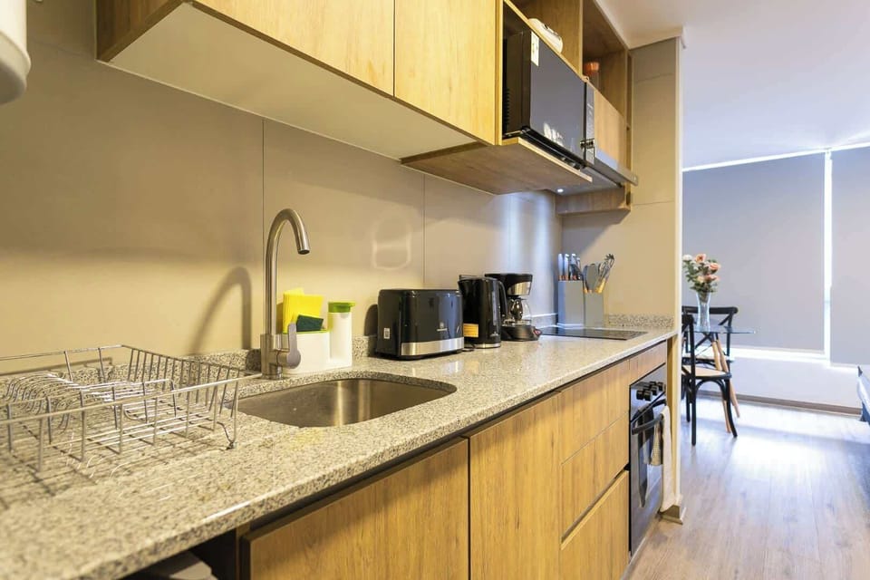 Modern kitchen with sleek granite countertops and all the essentials for a cozy stay.