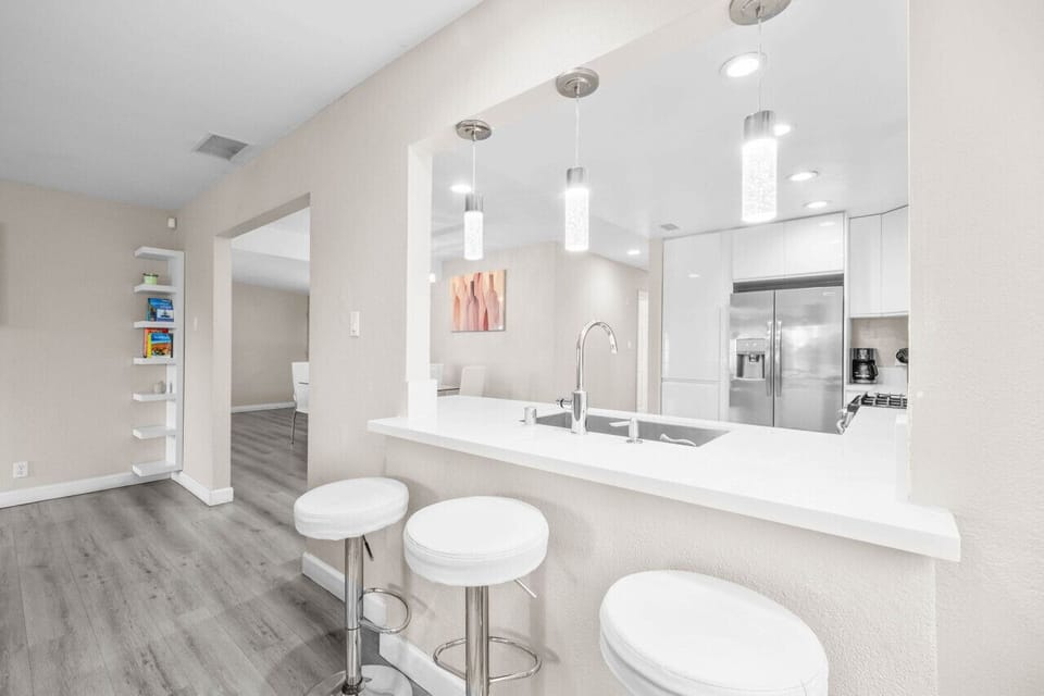 Start your day at this bright breakfast bar, complete with modern pendant lighting and cozy seating, perfect for casual meals or coffee breaks.