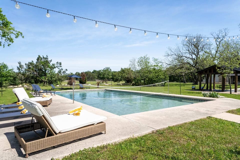 Private outdoor swimming pool and sun recliners.