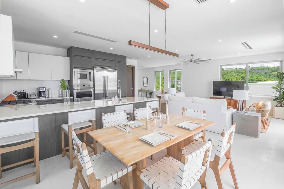 Dining area and gourmet kitchen in background.