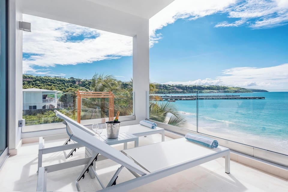 Relax on two chaise lounge chairs on your terrace over looking beach.