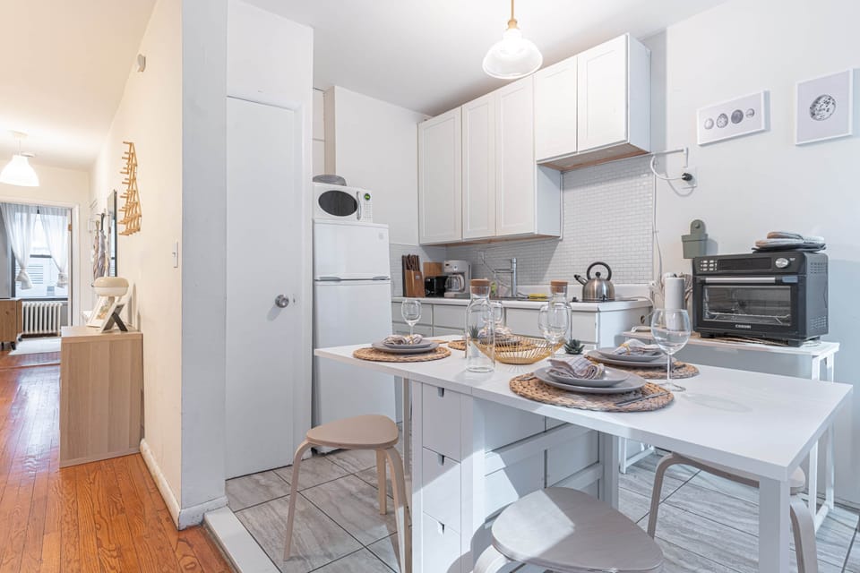 Stylish kitchen with dining table, full appliances & bright open layout