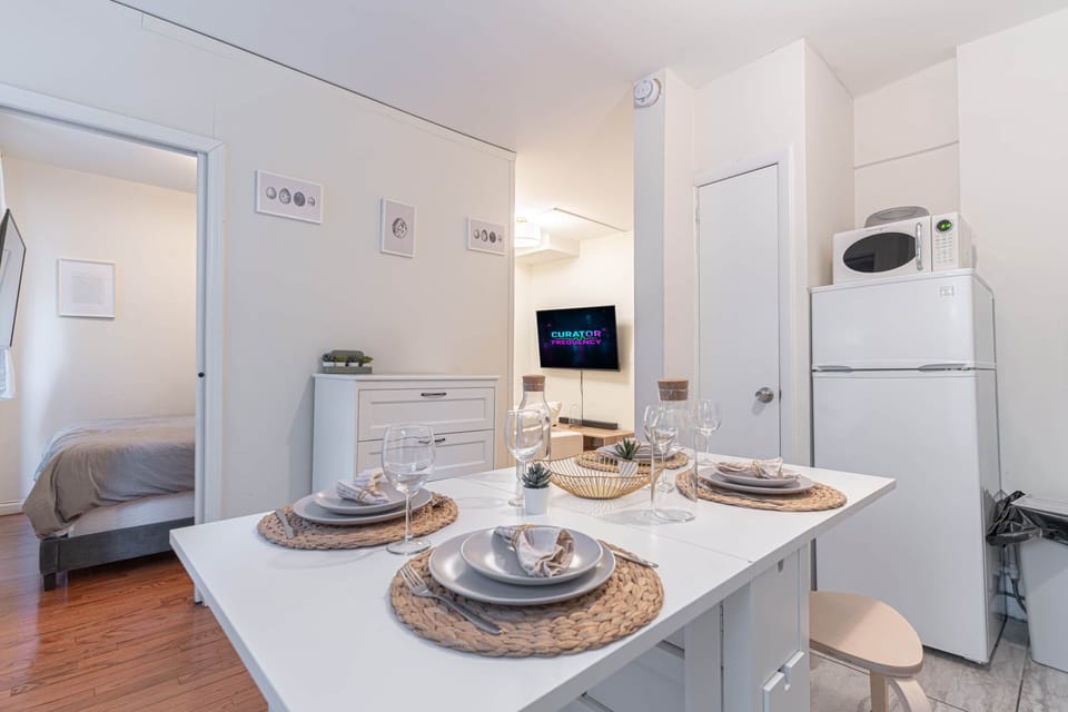 Open layout with dining for four, full kitchen & TV lounge view