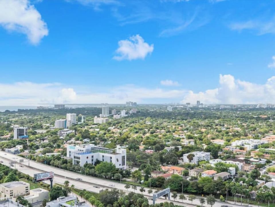 Expansive views of the lush cityscape and skyline from the balcony.