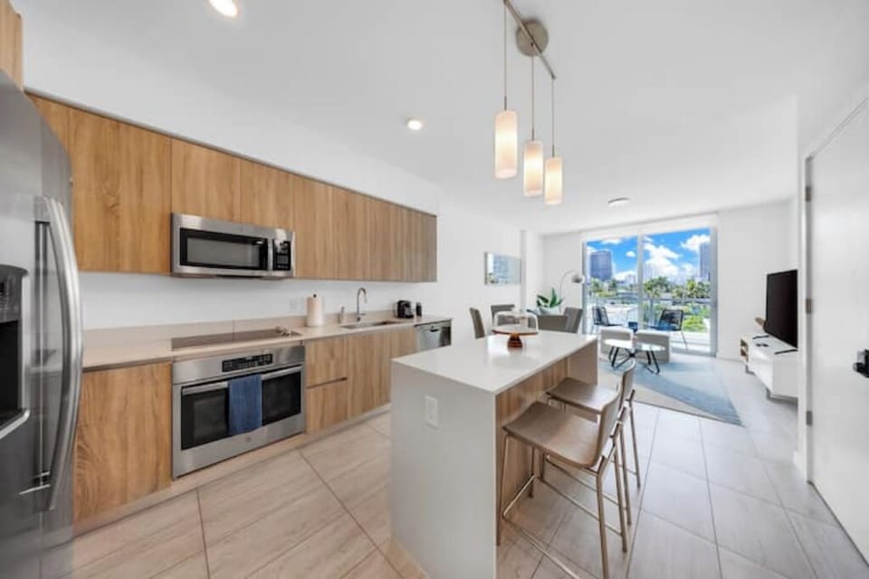 Fully equipped kitchen with sleek countertops and modern appliances.