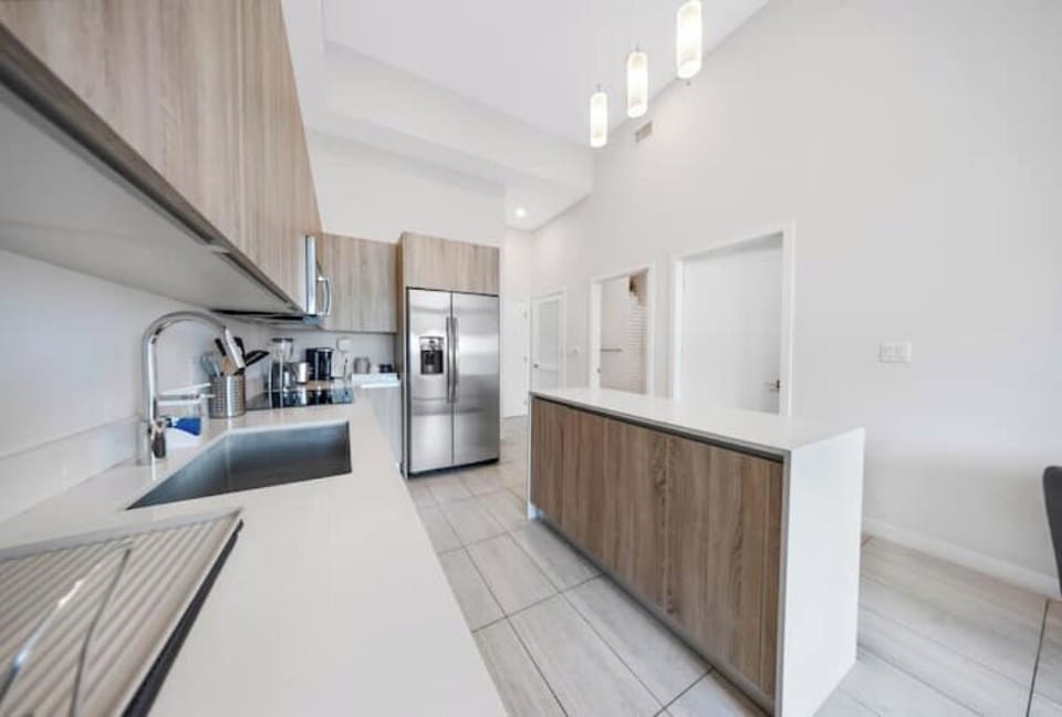 Sleek kitchen with modern appliances and ample counter space.