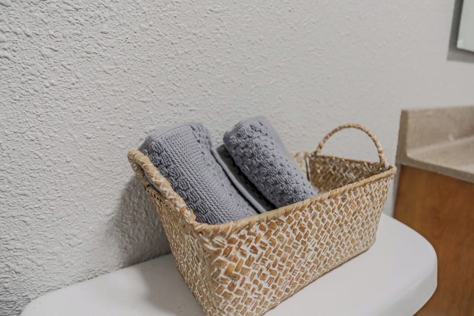 Clean and modern bathroom with a large shower, soft towels, and complimentary toiletries to make your stay more comfortable.