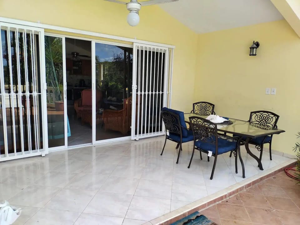 Main Entry w/ locking security bars. Covered Terrance extending living/dining.
