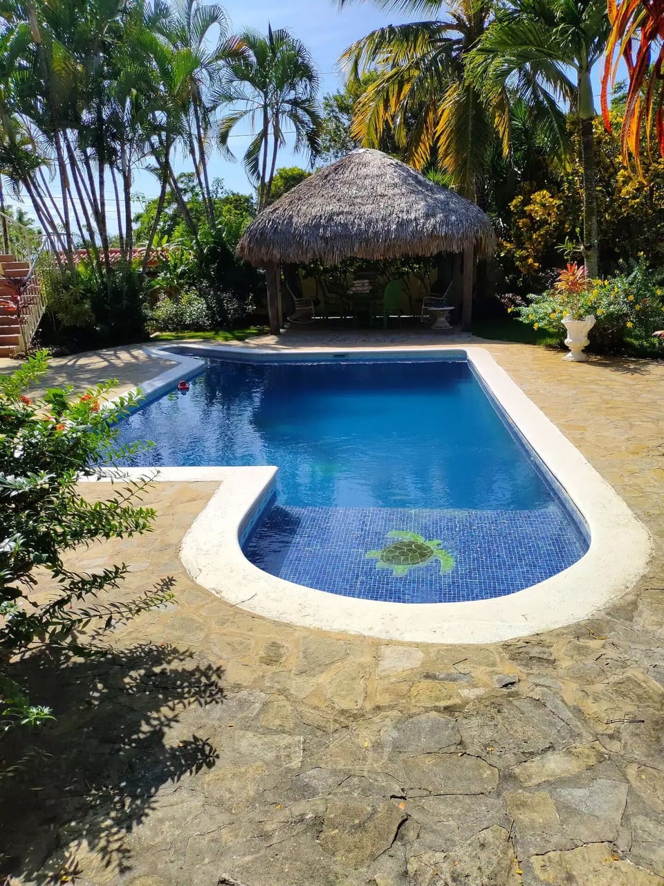 Private Pool with in pool sitting area. Pool side tiki and lounge chairs.