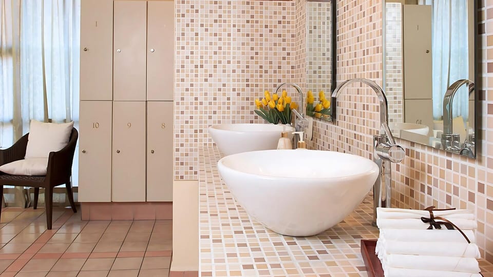Unwind in Villa del Palmar’s elegant spa locker room with tranquil ambiance.