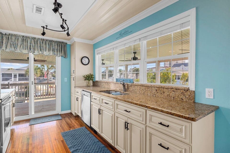 A bright and airy kitchen with plenty of counter space and a stunning view of the channel while you cook.