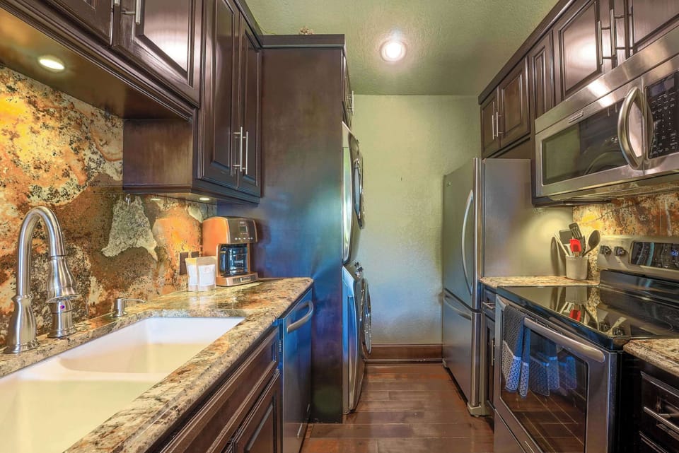 Whip up delicious meals in our fully-equipped kitchen, featuring modern appliances and elegant granite countertops.