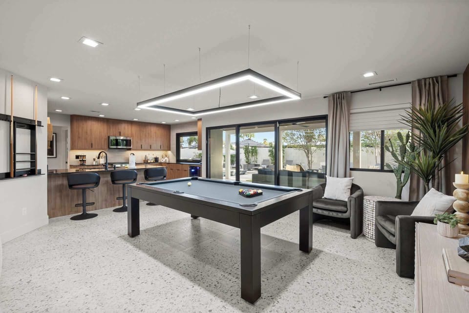 Enjoy a game of pool in this stylish entertainment space, perfect for fun and relaxation.