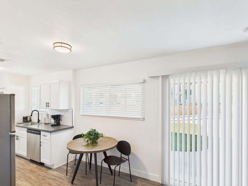 Fully equipped kitchen stocked with basic cooking essentials, stainless steel appliances, access to the shared backyard, and a washer and dryer.