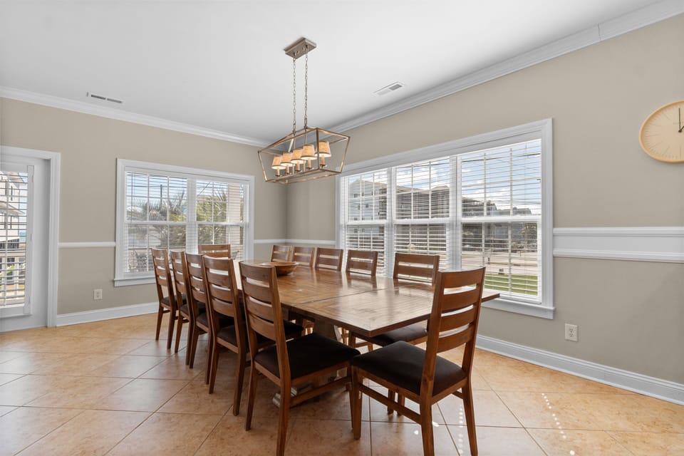 Gather around your spacious dining table for memorable meals together, with natural light streaming through large windows.