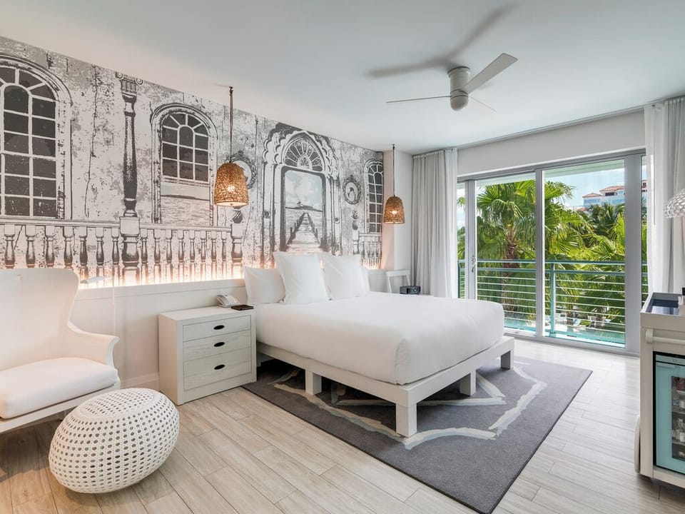 Stretch out in crisp linens beside lush tropical views.