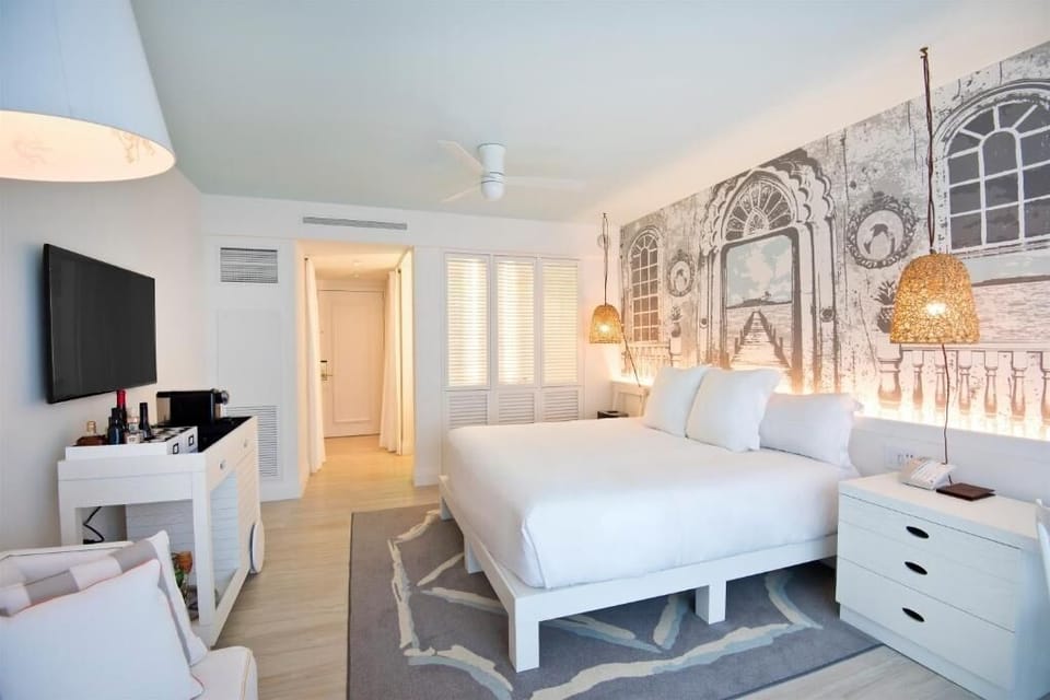 Unwind with a movie and minibar after beach days.