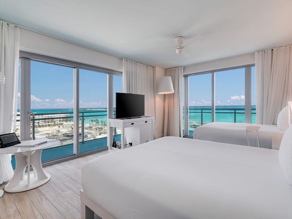 Wake up to turquoise ocean views from crisp white beds.