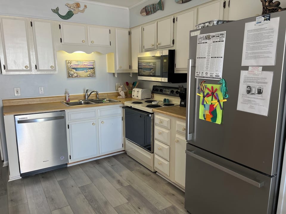 Kitchen has Keurig and coffee pot as well as dishwasher