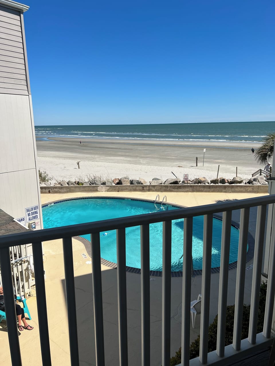 View of beach and pool from balcony