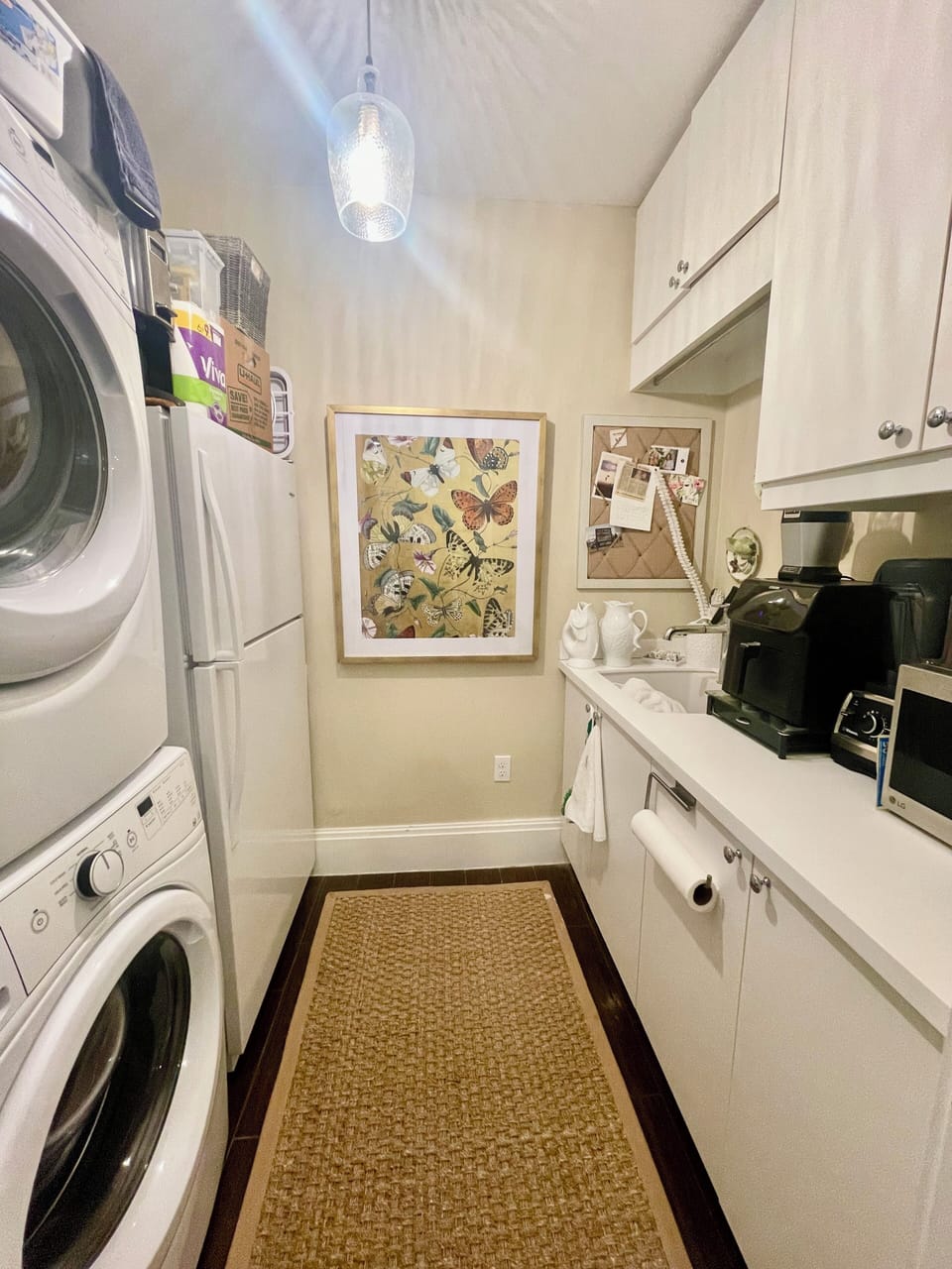 Laundry room with washer and dryer and extra refrigerator/freezer.