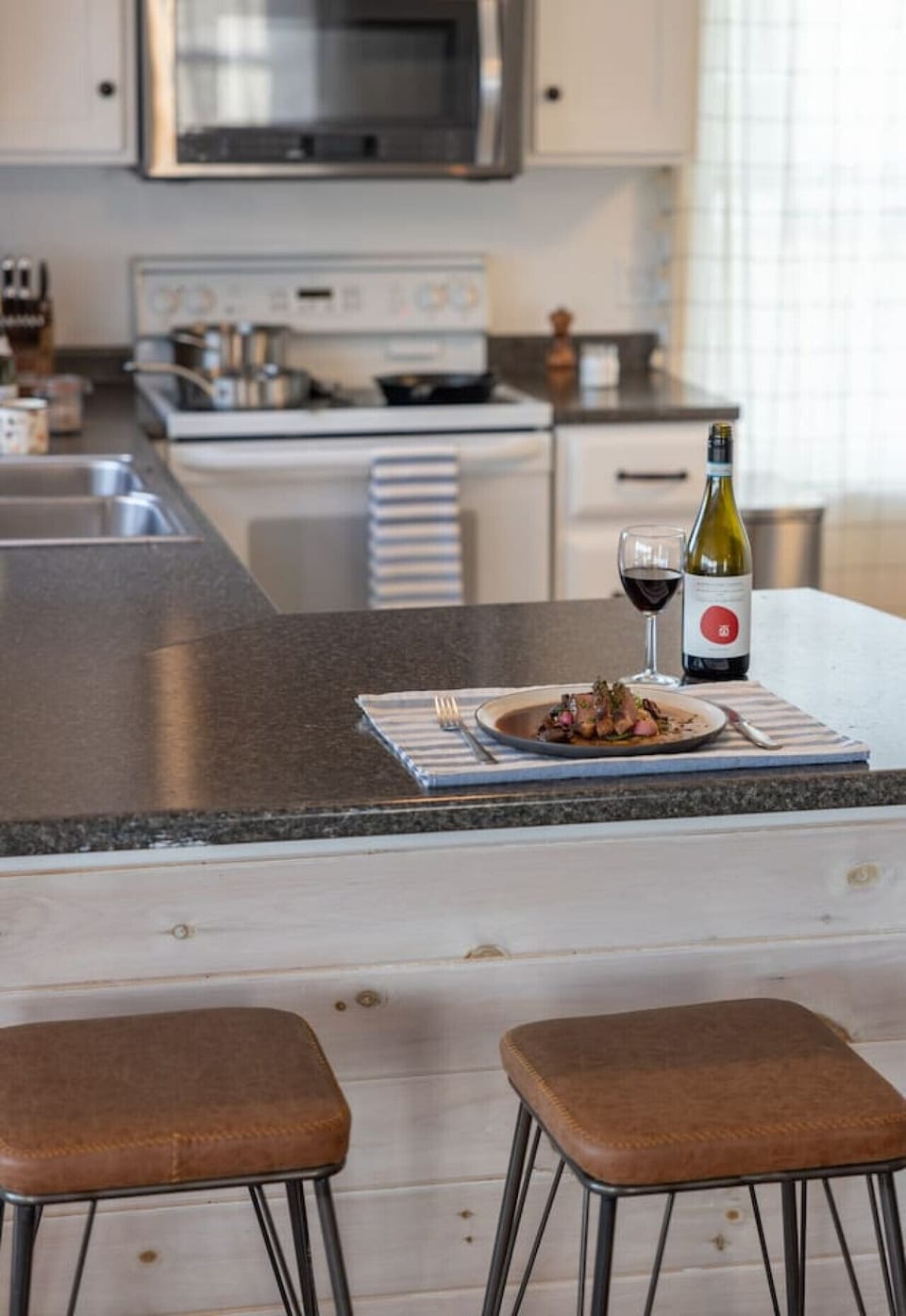 The fully stocked kitchen opens up to the living/dining area.