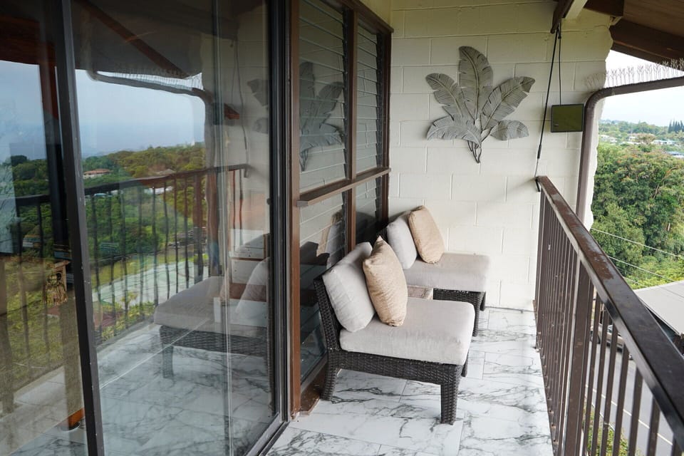 Private balcony with cozy seating and lush views