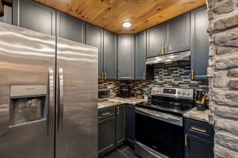 “Modern kitchen with stainless steel appliances and warm wood finishes.