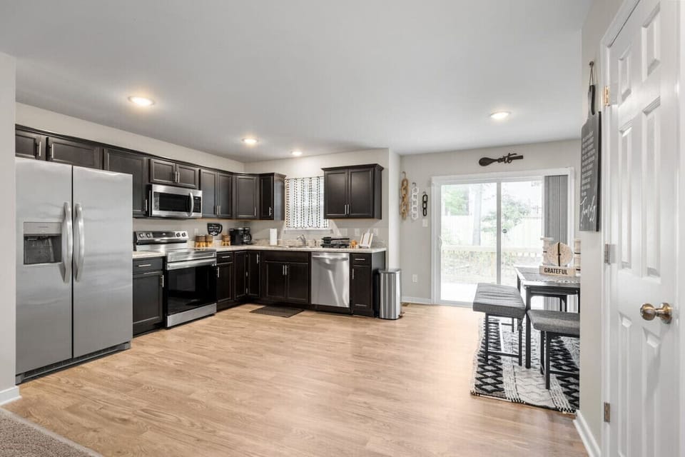 Cook up a storm in this sunlit kitchen, featuring a stove, oven, microwave, dishwasher, and fridge/freezer. Fully stocked with dinnerware, cutlery, and everything you need for gourmet meals.