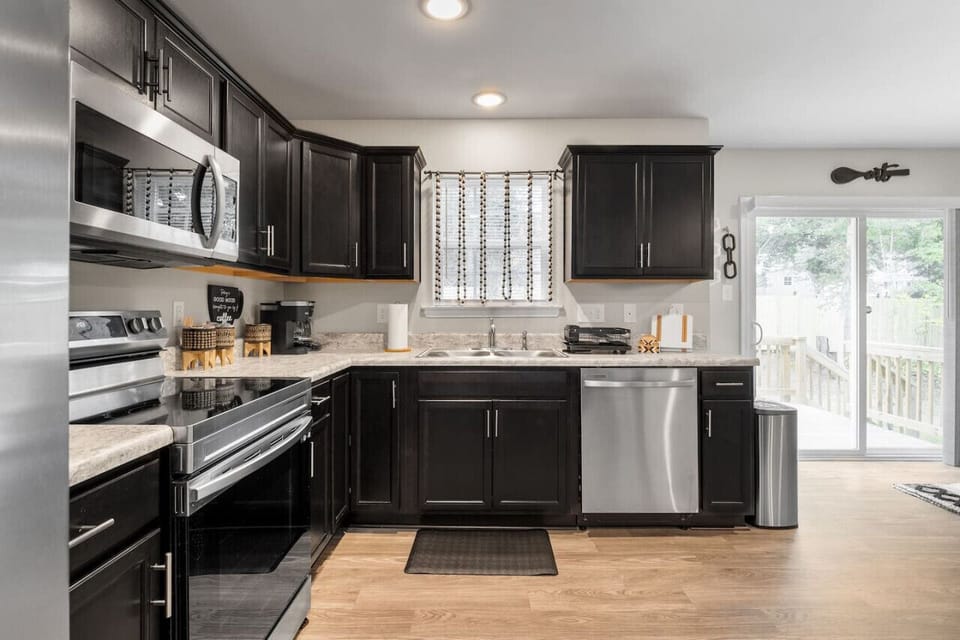 Cook up a storm in this sunlit kitchen, featuring a stove, oven, microwave, dishwasher, and fridge/freezer. Fully stocked with dinnerware, cutlery, and everything you need for gourmet meals.