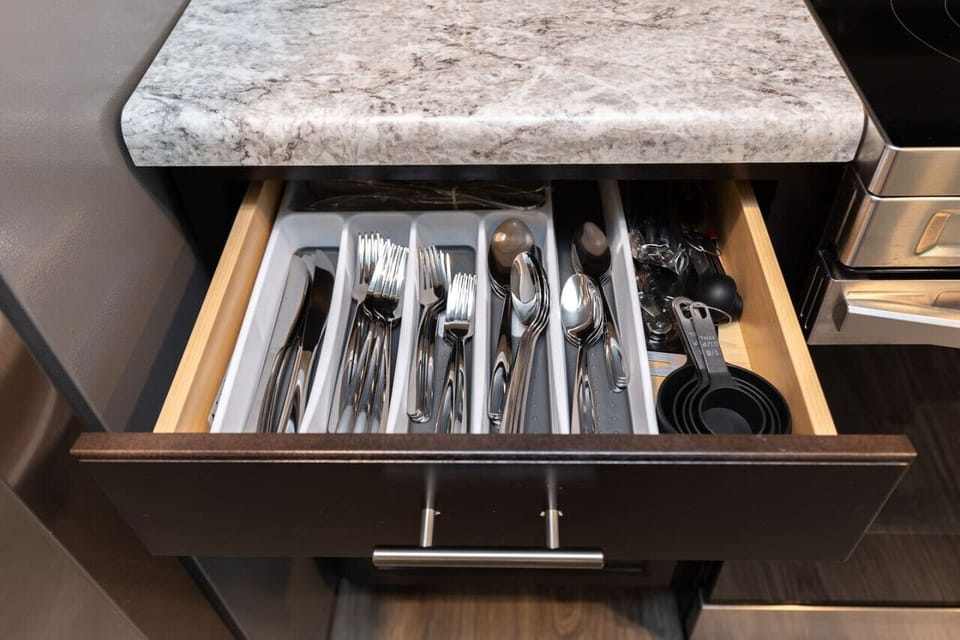 Cook up a storm in this sunlit kitchen, featuring a stove, oven, microwave, dishwasher, and fridge/freezer. Fully stocked with dinnerware, cutlery, and everything you need for gourmet meals.