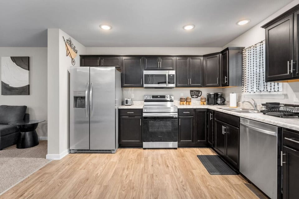 Cook up a storm in this sunlit kitchen, featuring a stove, oven, microwave, dishwasher, and fridge/freezer. Fully stocked with dinnerware, cutlery, and everything you need for gourmet meals.