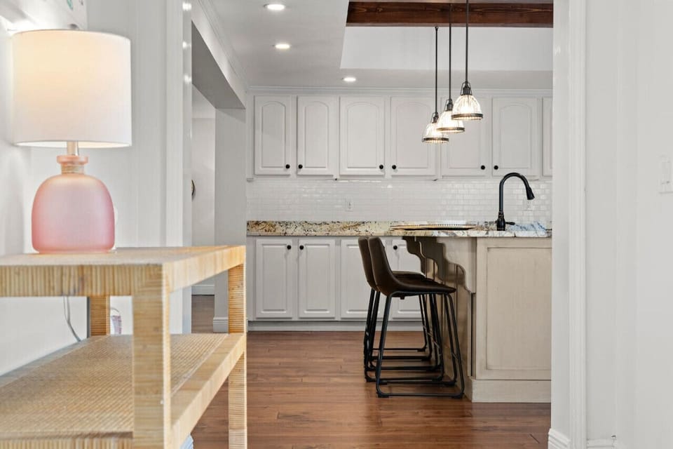 A bright, updated kitchen featuring a stylish breakfast bar island, perfect for casual dining and entertaining.