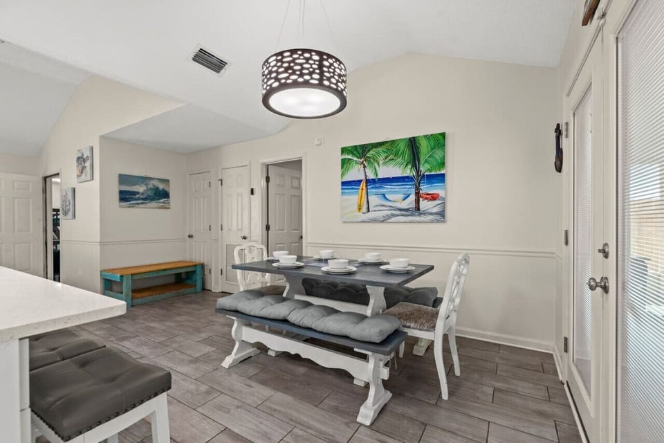 Sleek dining room, open to kitchen with breakfast bar and outdoor access!