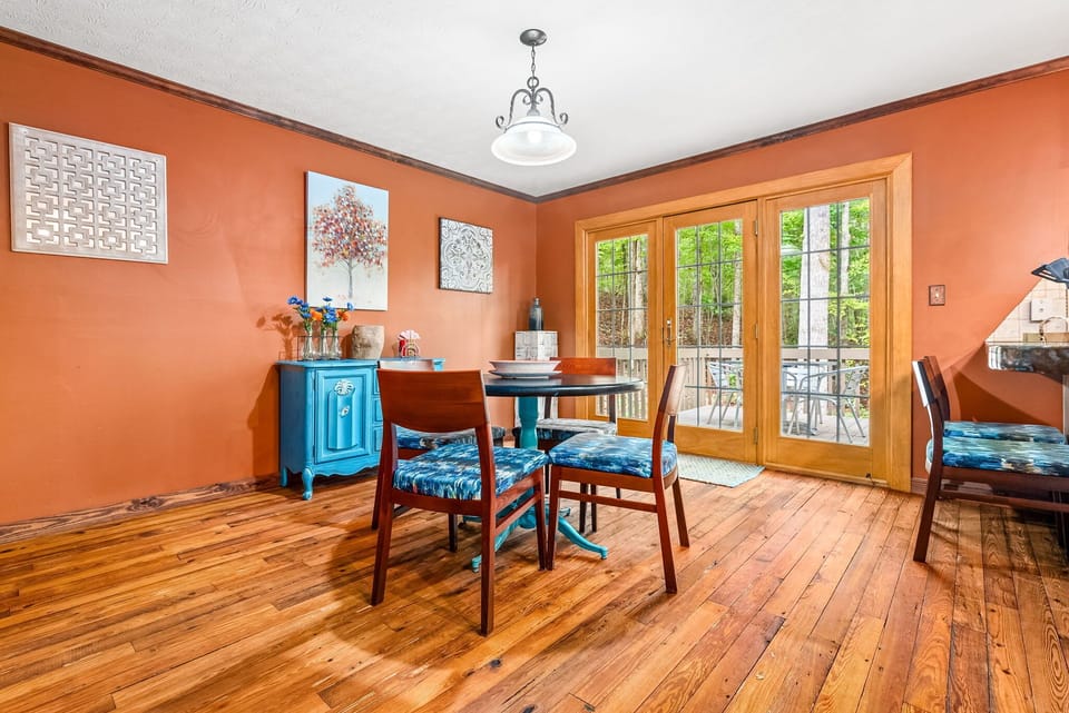 This charming kitchen nook, complete with a colorful and stylish table, provides a cozy space for casual meals. The large glass doors offer easy access to the deck, allowing you to seamlessly transition from indoor dining to the fresh air outdoors.